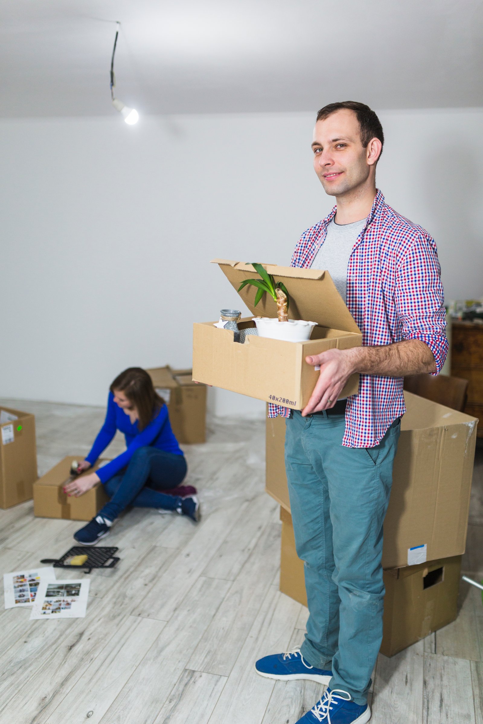 Customer holding a moving box at a new home